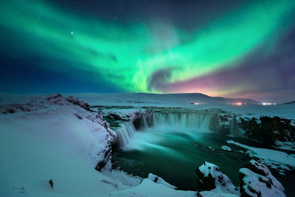 The Northern Lights are one the most romantic dates in Iceland The Northern Lights over Godafoss Waterfall are the perfect romantic evening