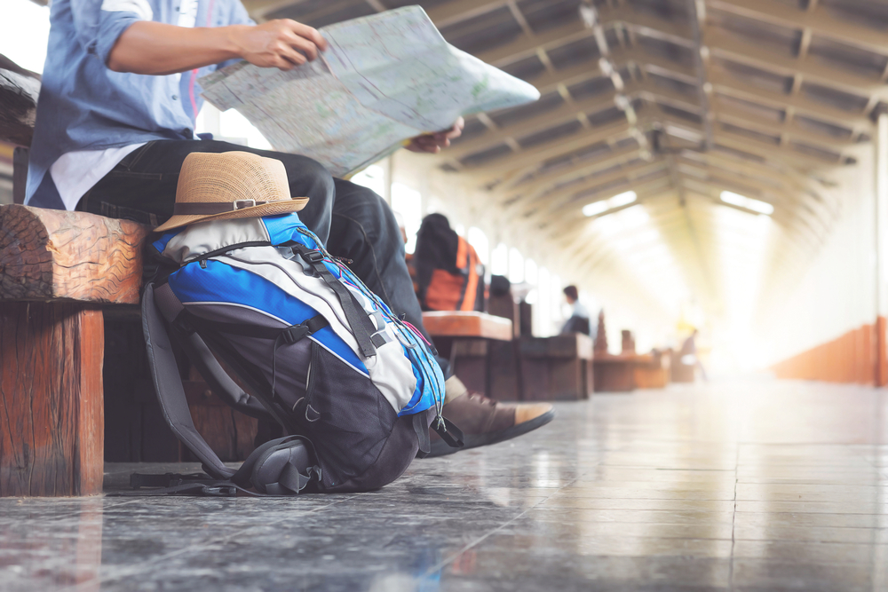 Traveling alone will change your life. Be open minded and friendly Solo traveler looking at a map and overcoming fear of travel