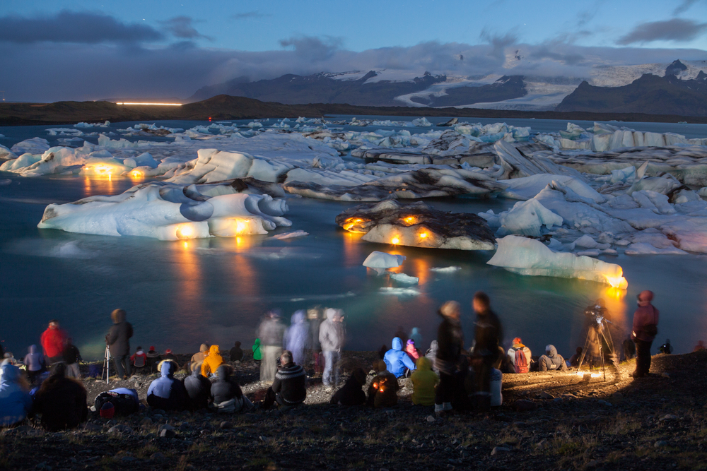 Tourists watching Jökulsárlón glacier lake fireworks display in Iceland in summer